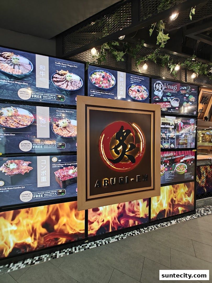 The shop front of Aburi-EN Suntec City, showcasing various Japanese rice bowls and grilled dishes.