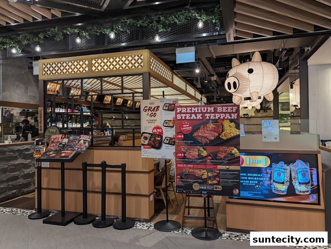 A Japanese restaurant shop front with a prominent pig lantern and promotional posters.