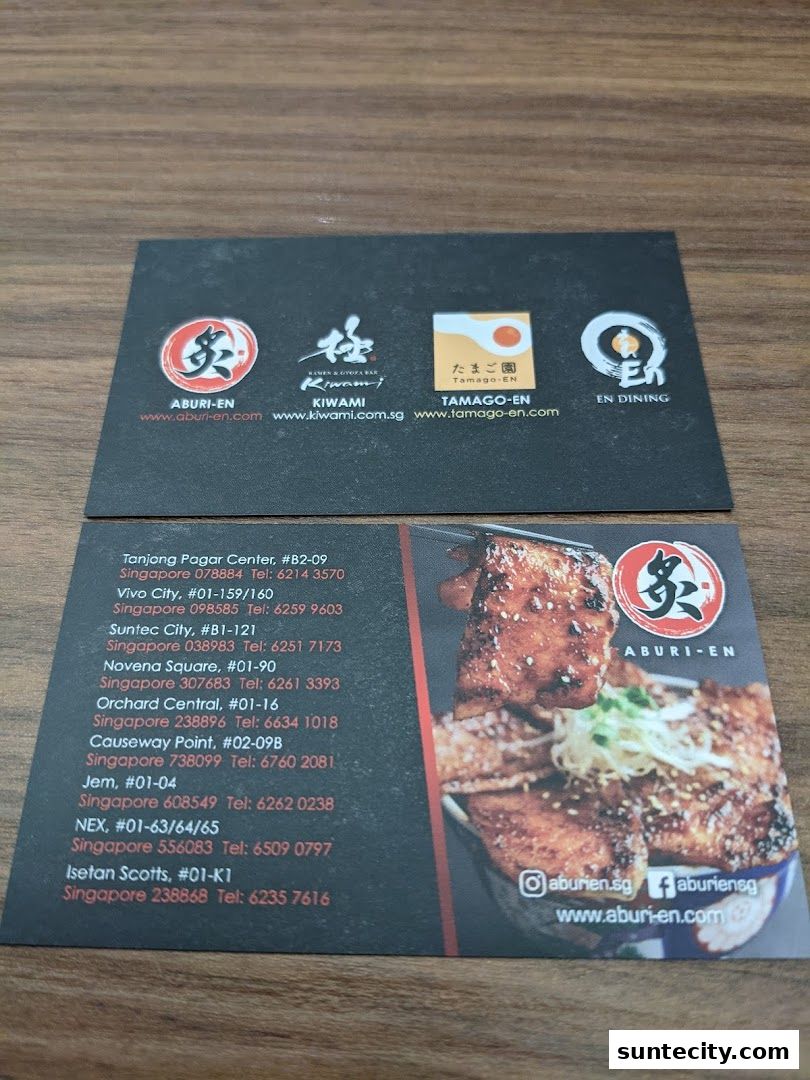 Business cards for Aburi-EN and its sister brands, featuring restaurant locations and contact information.