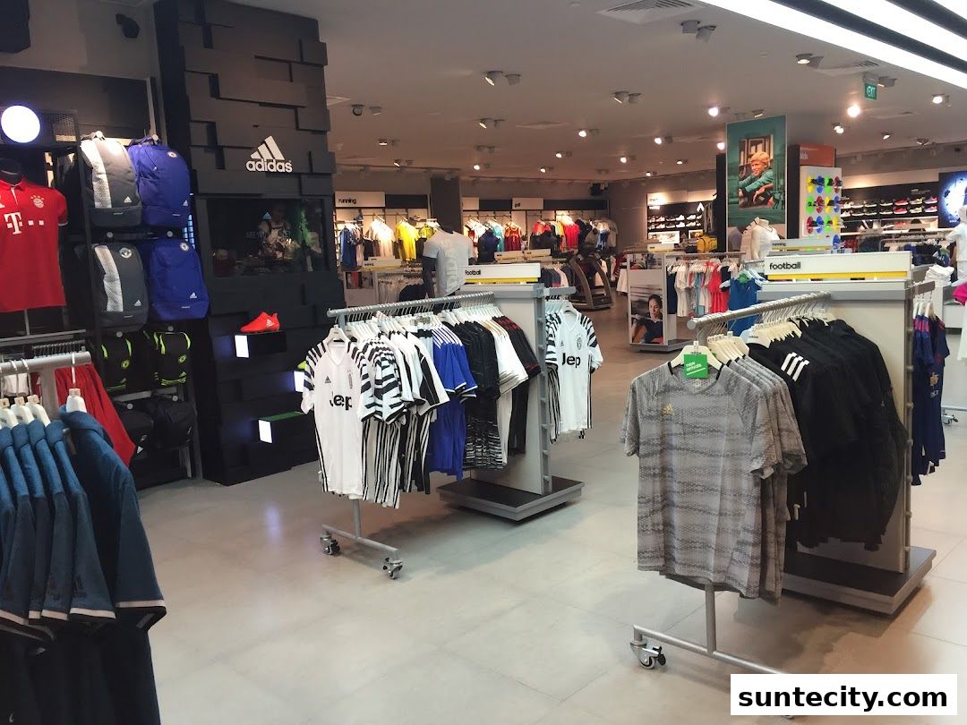 Interior of an Adidas Performance Store showcasing sportswear, including jerseys, backpacks, and shoes.