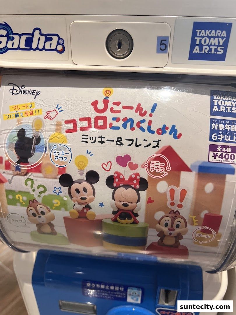 A gacha machine featuring Disney's Mickey & Friends characters.