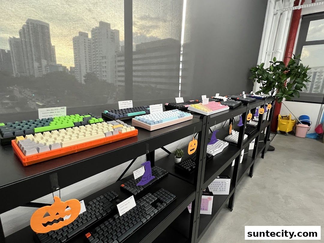 A display of various mechanical keyboards on shelves, with Halloween decorations.
