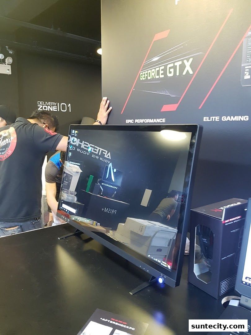 A computer monitor displaying the Aftershock PC logo and a GeForce GTX advertisement.