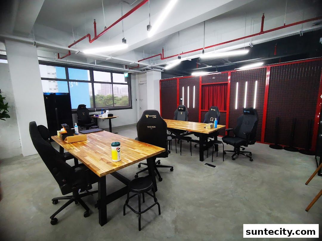 Interior of a gaming setup with multiple gaming chairs and tables.