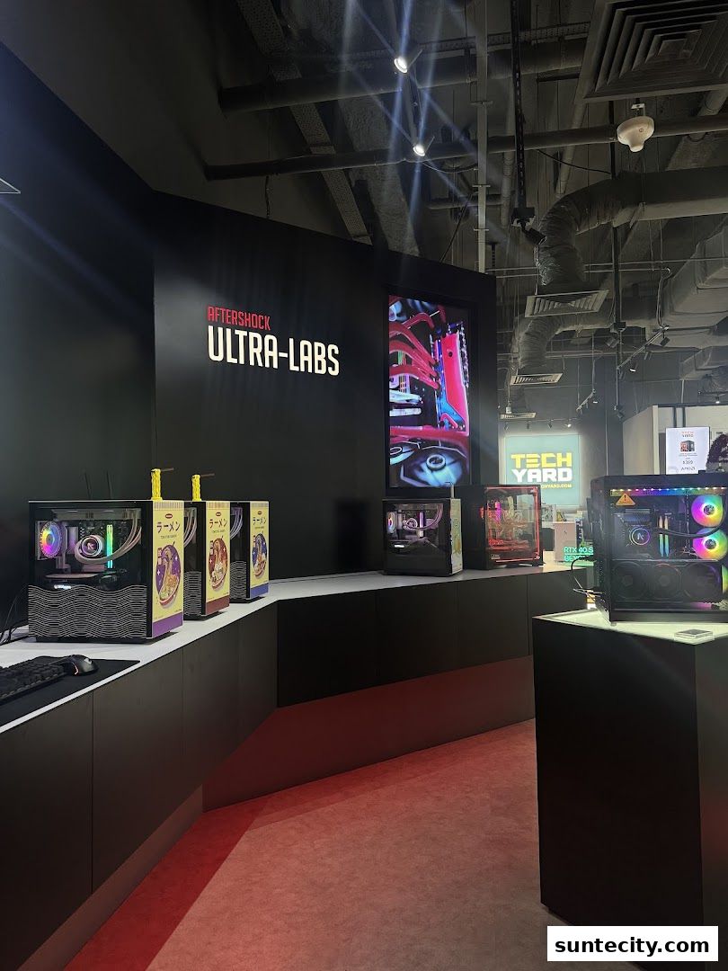 AFTERSHOCK PC store interior showcasing custom-built gaming computers and components.