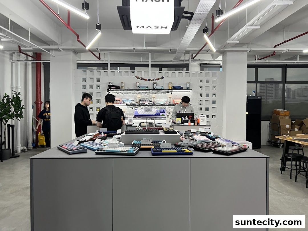 Customers browse a wide selection of colorful mechanical keyboards displayed on a counter.