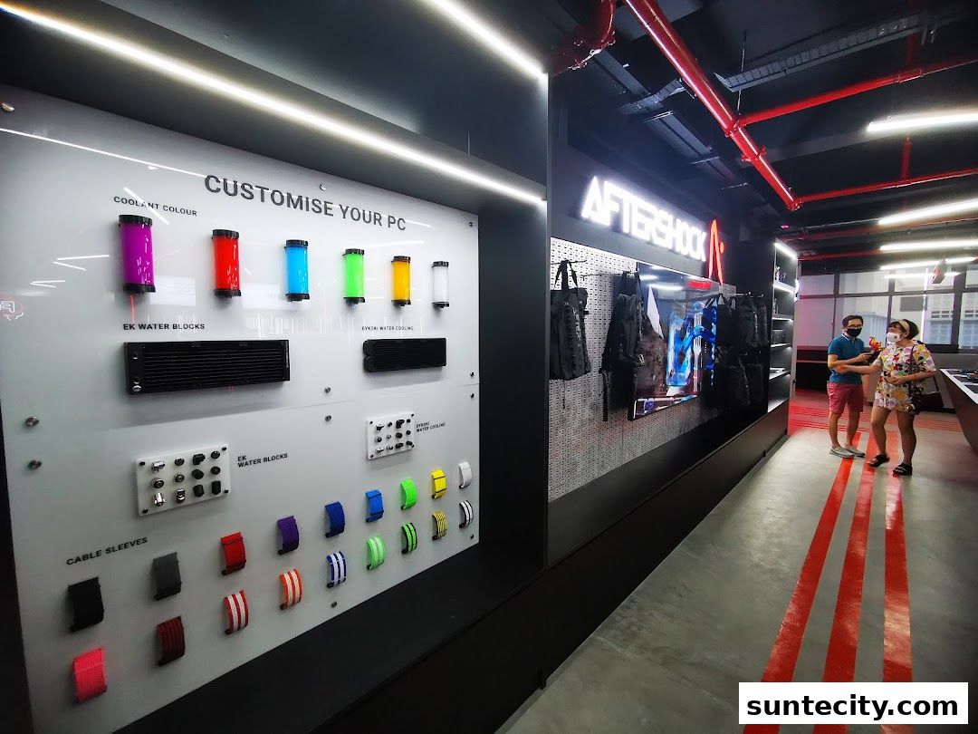 Interior of a PC customization shop showcasing coolant colors, water blocks, and cable sleeves.