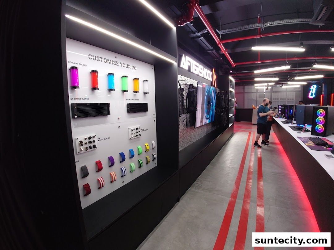 Interior of a modern PC customization shop with display of PC components and customers.