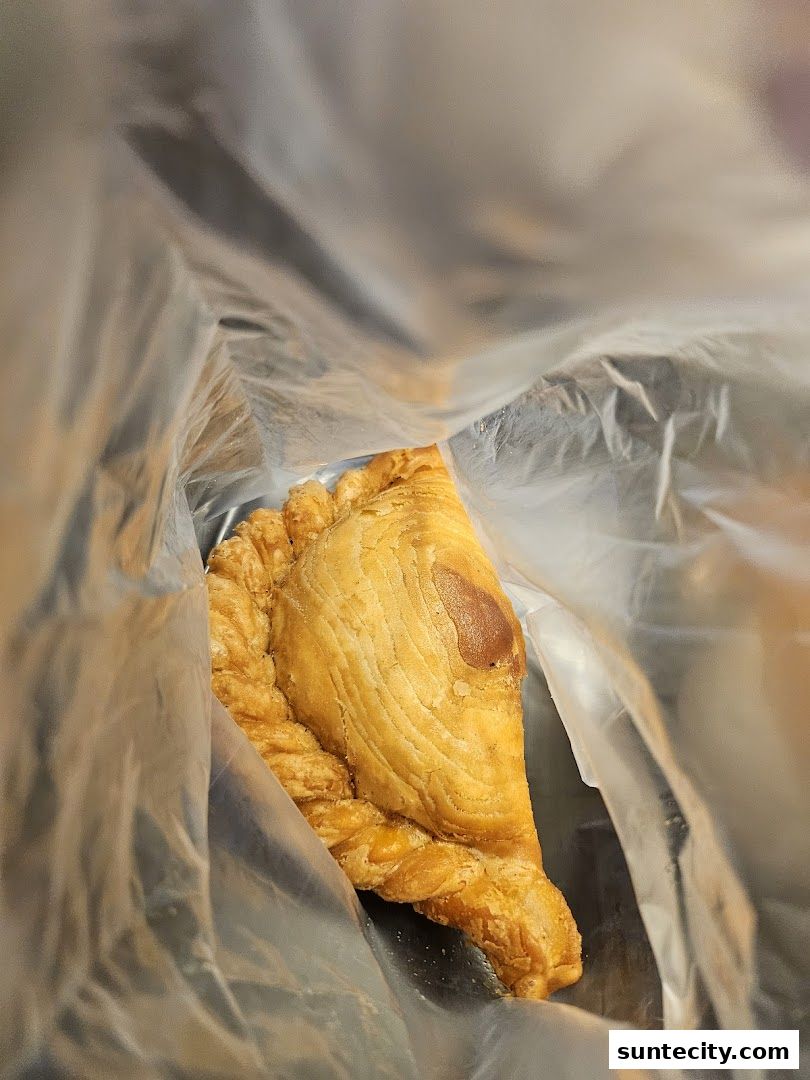 A close-up shot of a golden-brown pastry inside a clear plastic bag.