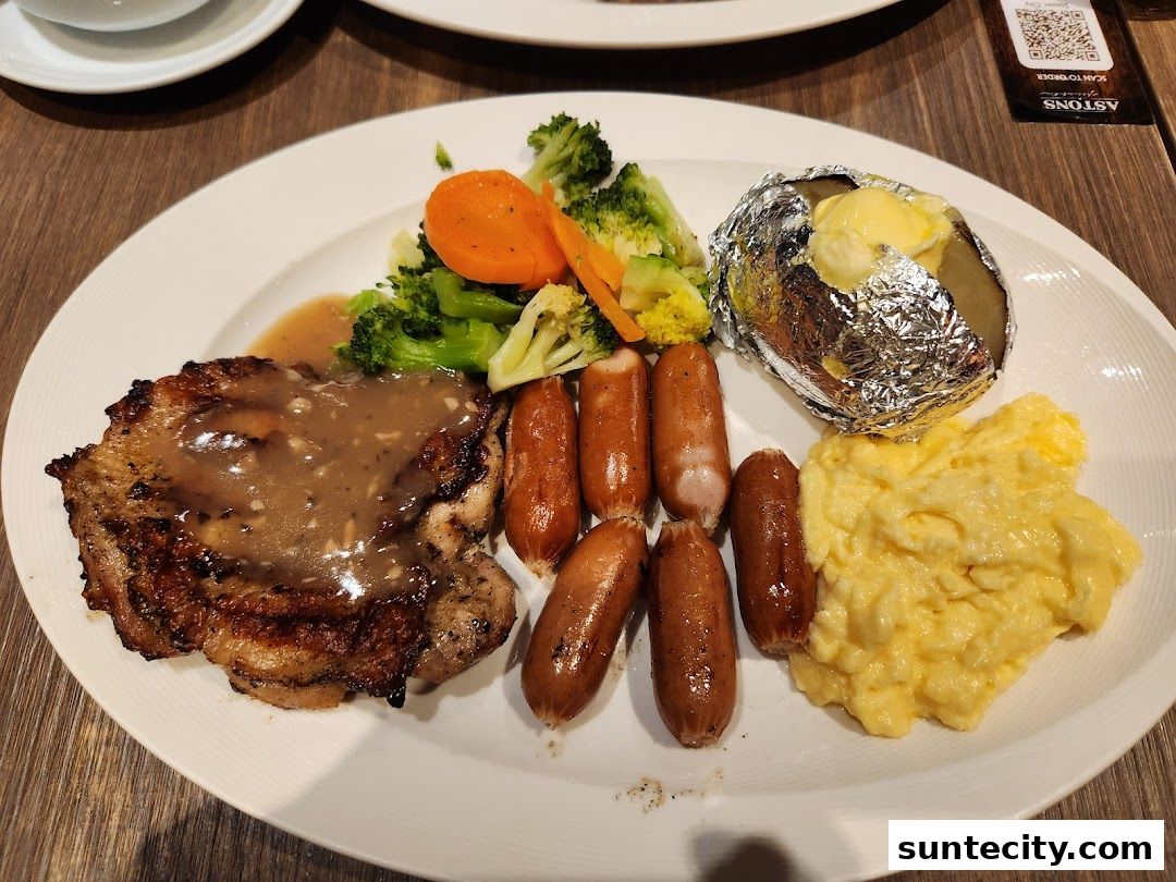 A hearty meal featuring grilled chicken, sausages, scrambled eggs, baked potato, and vegetables.