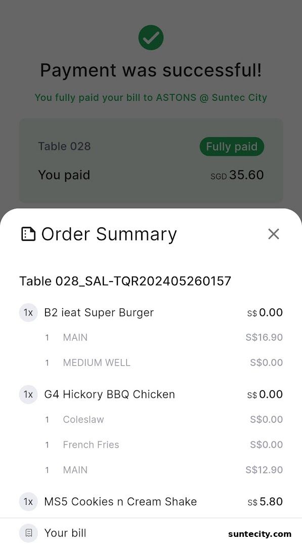 A successful payment confirmation screen for ASTONS Specialities at Suntec City.
