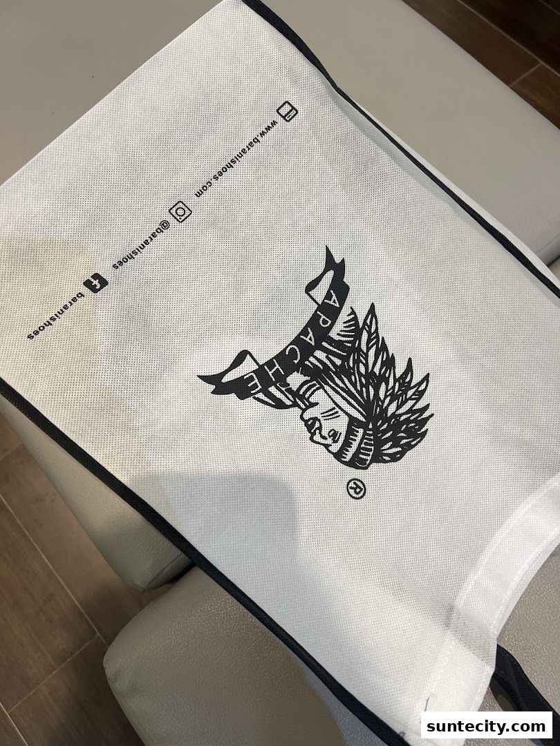 A white shopping bag with the Barani Shoes logo and social media handles.