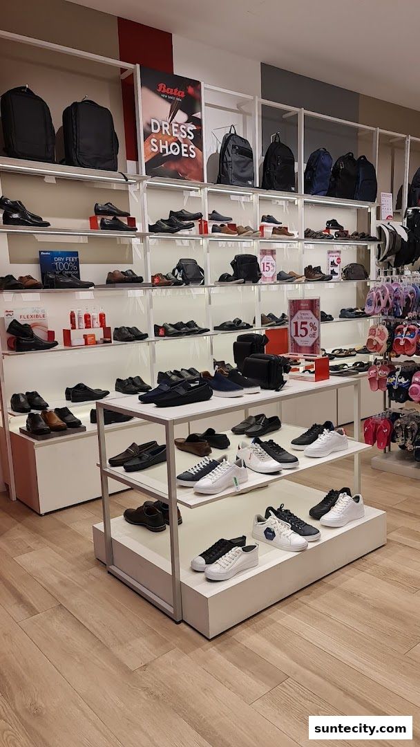 Interior view of a Bata shoe store showcasing various footwear and bags on display shelves.