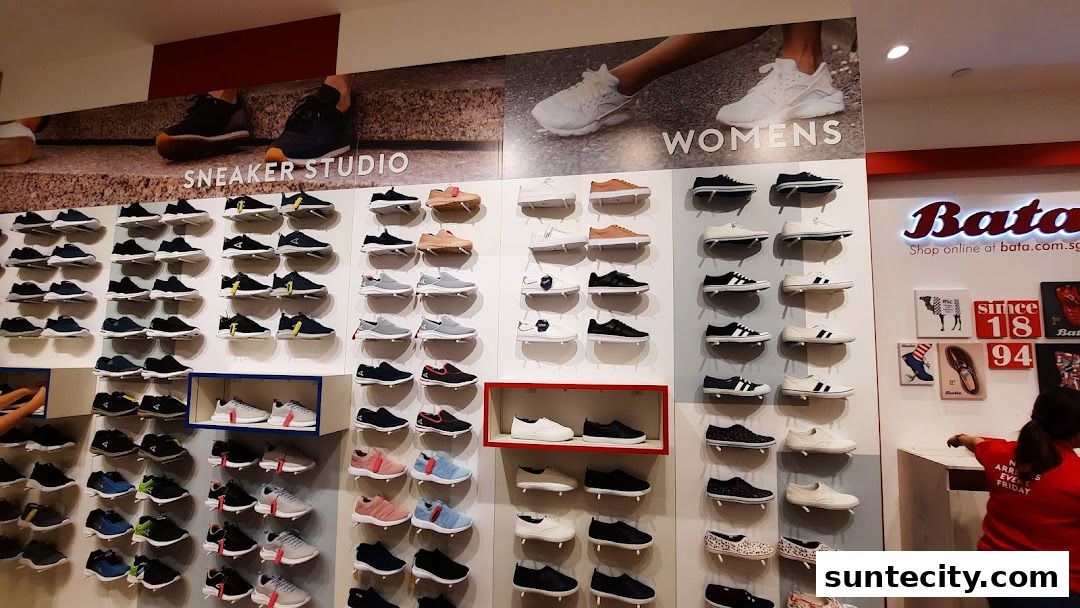 A wide selection of shoes displayed on shelves in a Bata store.