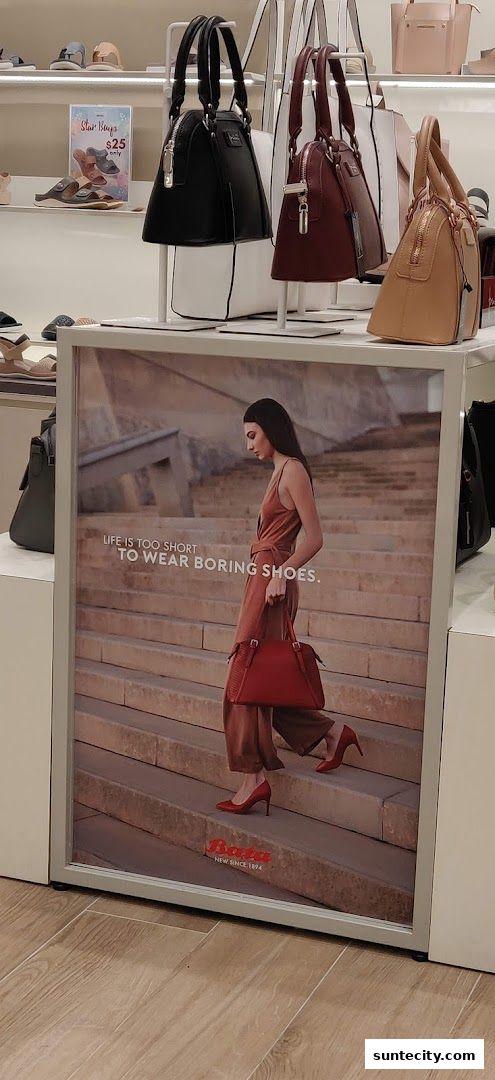 A Bata advertisement featuring a woman in stylish red shoes and a matching handbag.