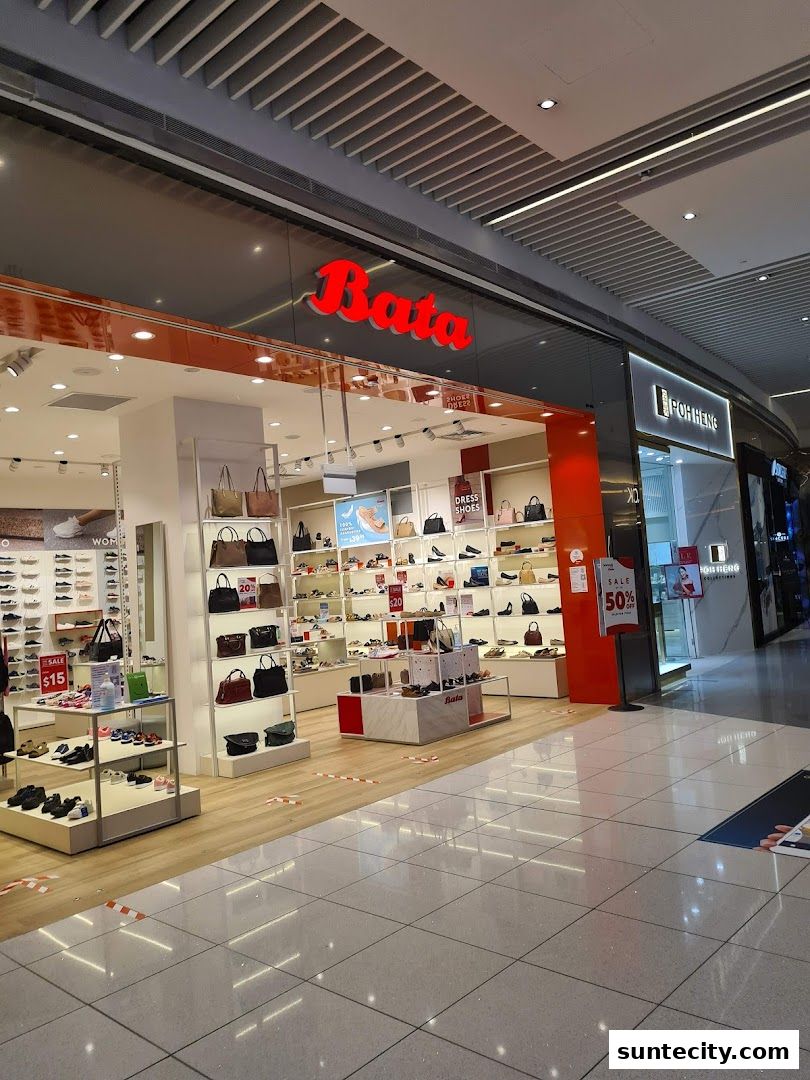 The Bata shoe store entrance displays a variety of shoes and handbags, with sale signs visible.