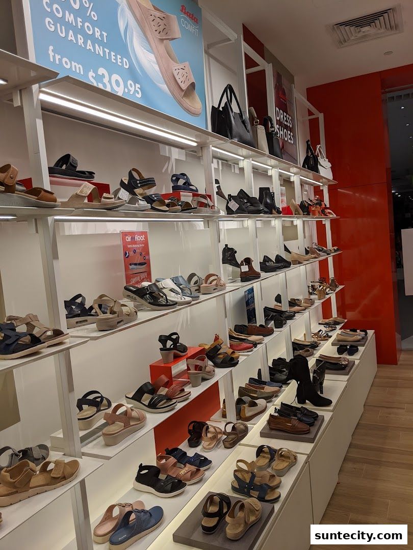 A well-lit display of various women's sandals and shoes on shelves at a Bata store.