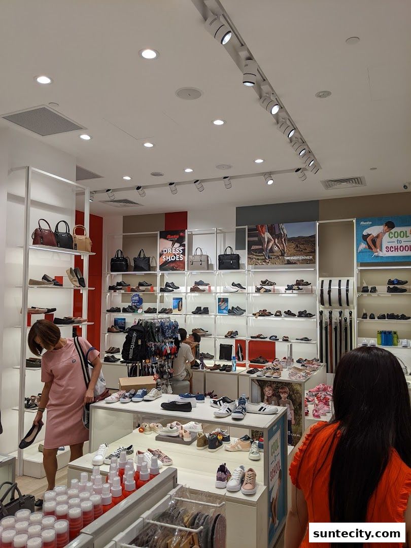 Interior of a Bata shoe store with various shoes and handbags displayed on shelves.