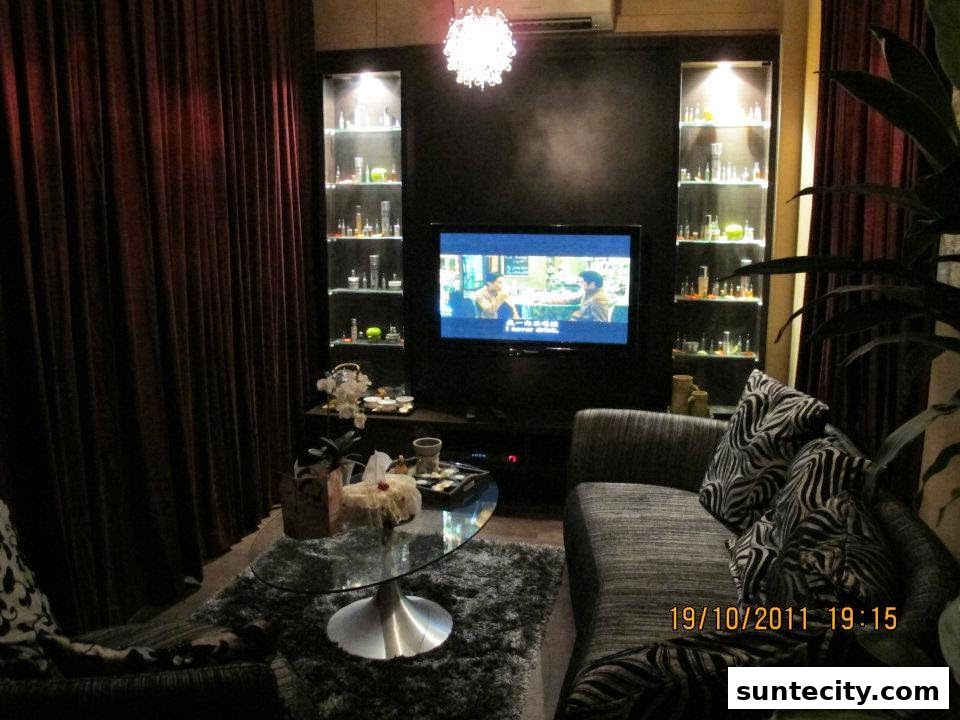 A cozy waiting area with a sofa, coffee table, and display shelves with products.