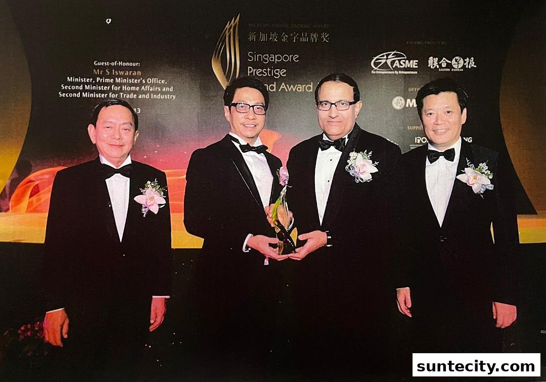 Four men in formal wear pose for a photo at an awards ceremony.