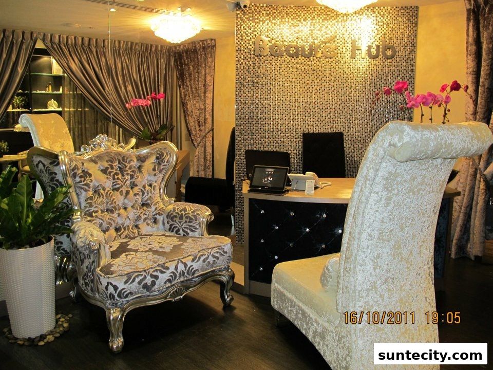 Interior of a luxurious beauty salon with ornate chairs and a reception desk.