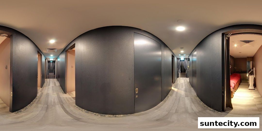 A panoramic view of a spa's interior hallway with treatment rooms.