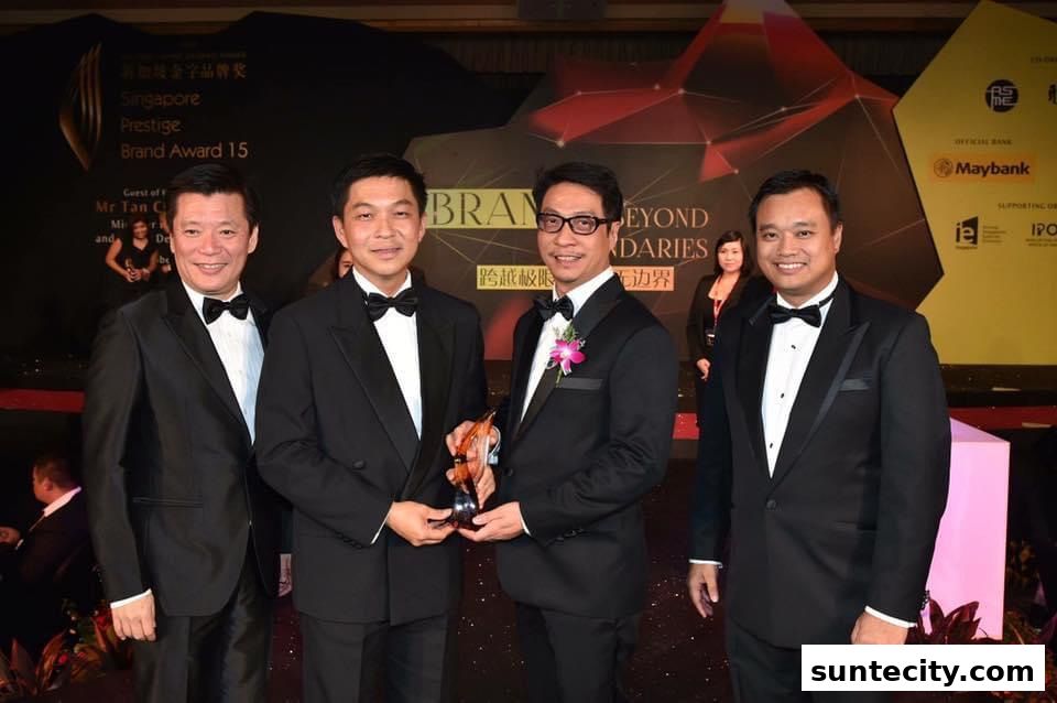 Four men in formal wear pose for a photo at an awards ceremony.