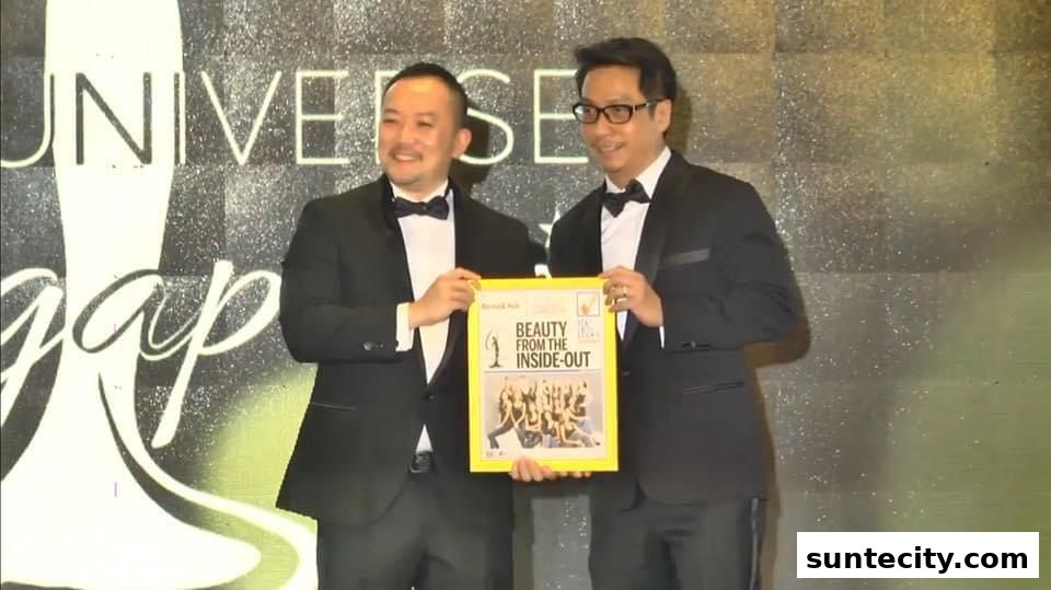 Two men in tuxedos hold a framed award with the text "BEAUTY FROM THE INSIDE-OUT".