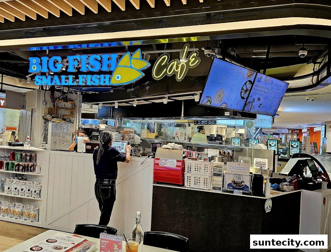 The Big Fish Small Fish Cafe counter with staff and digital menus displayed.