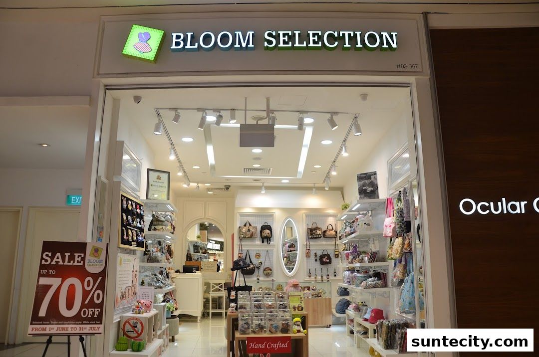The storefront of Bloom Selection, a shop selling bags and accessories, with a sale sign outside.