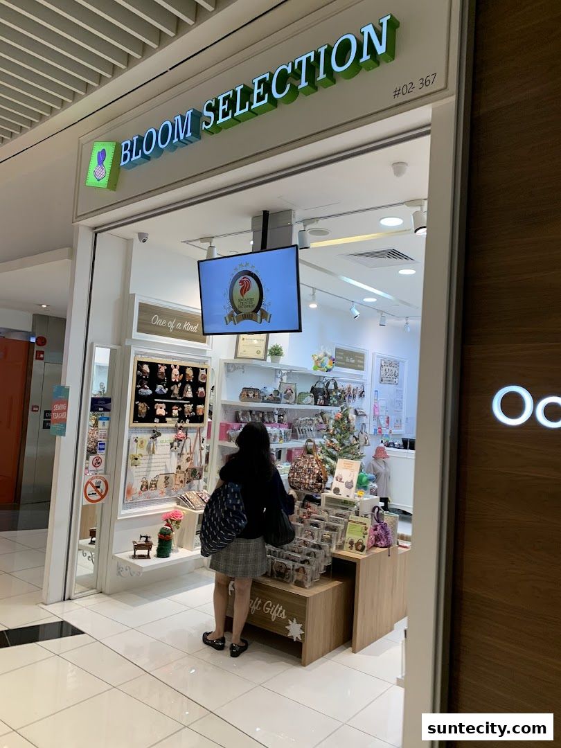 A woman browses a selection of unique gifts and accessories at Bloom Selection.