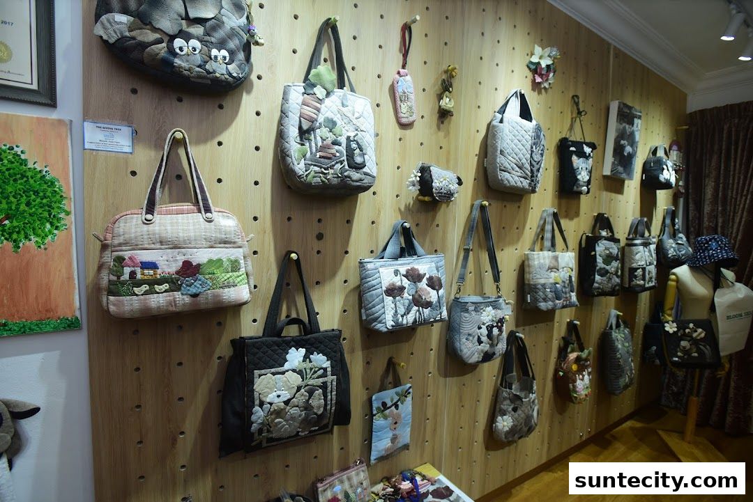 A wall display showcasing a variety of handcrafted quilted bags with unique designs.