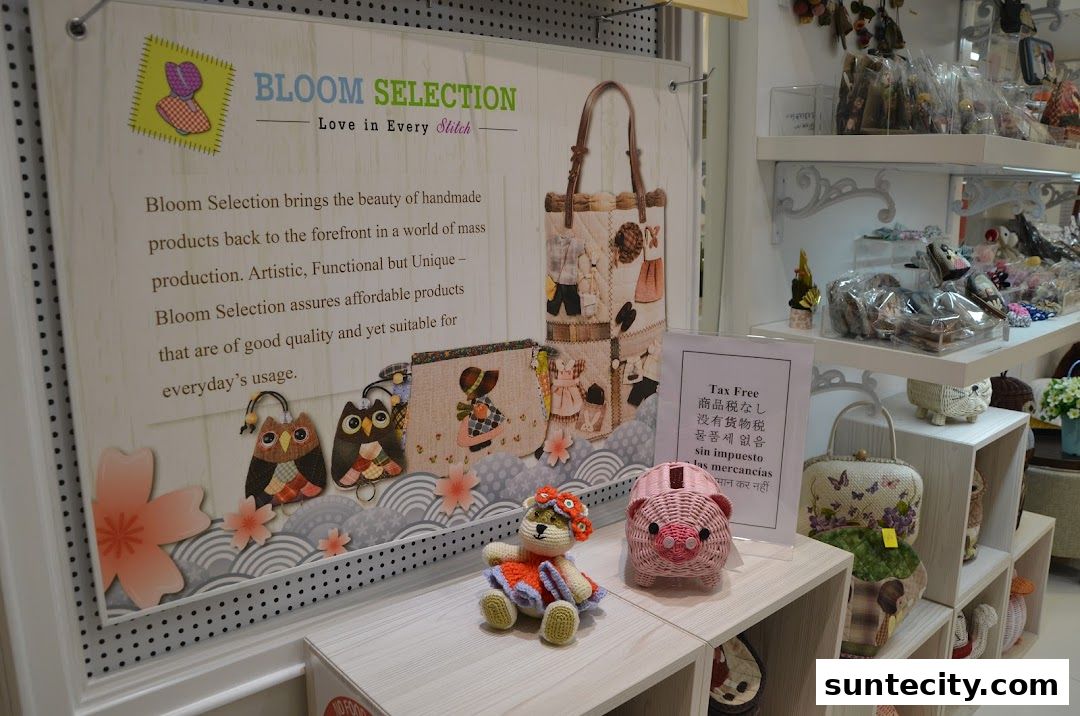 A display of handmade bags and crafts at Bloom Selection, featuring owls, a pig, and a teddy bear.