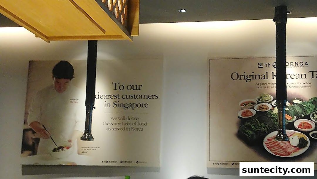 Posters inside Bornga Singapore showcasing Korean cuisine and a chef.