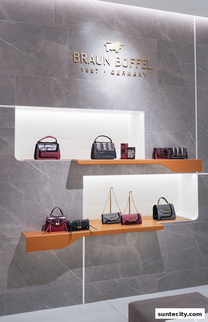Braun Büffel shop interior showcasing various handbags on display shelves.