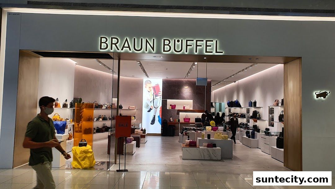 The exterior of a Braun Büffel store, showcasing handbags and accessories with a "SALE" sign.