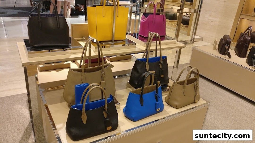 A display of various leather handbags in different colors and styles.