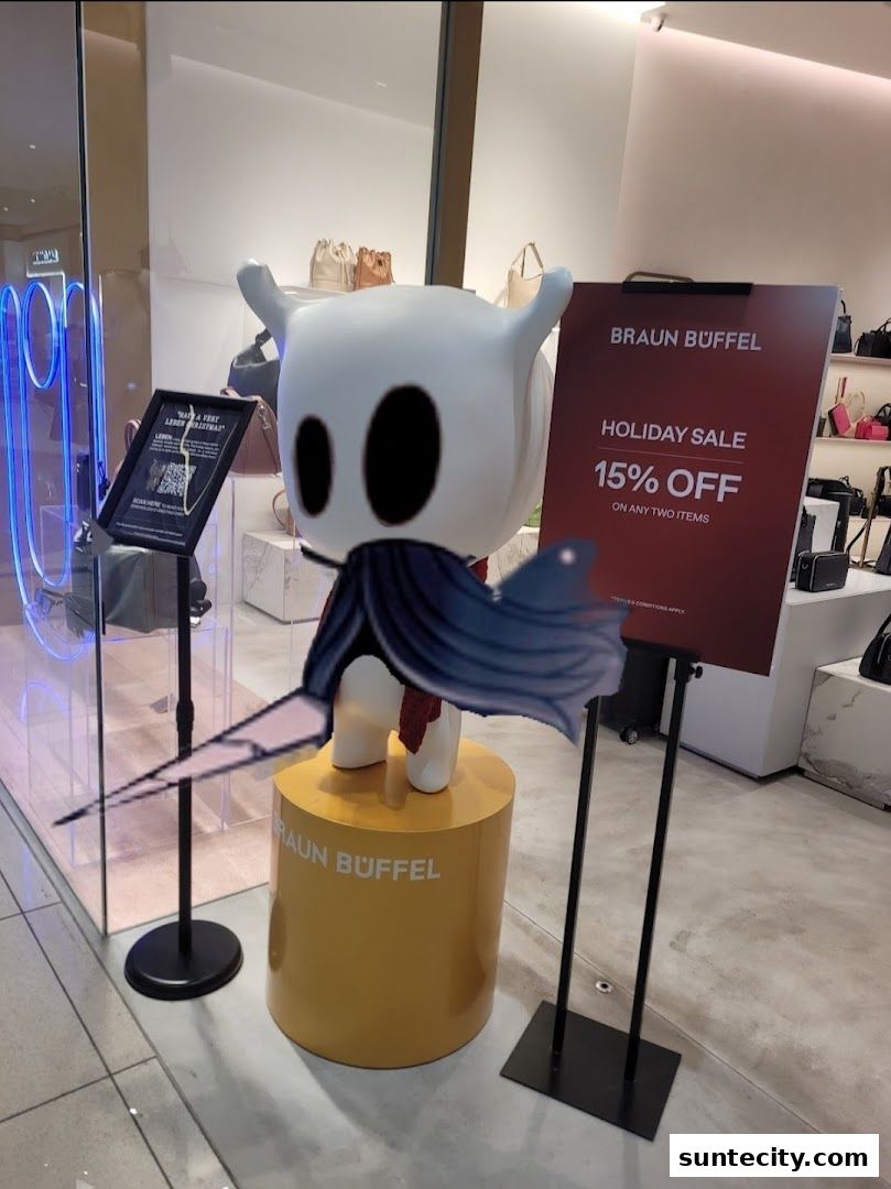 Braun Buffel store window display featuring a character statue and a holiday sale sign.
