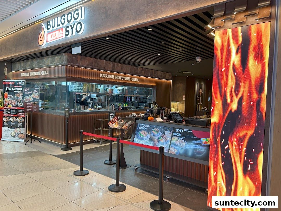 The exterior of Bulgogi Syo, a Korean Hotstone Grill restaurant, with a vibrant flame display.