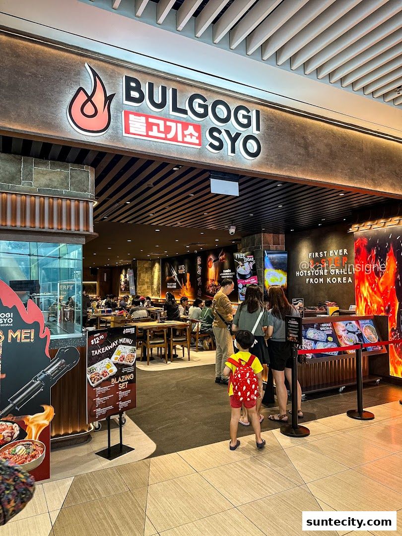 The entrance of Bulgogi Syo restaurant with a sign and people queuing.