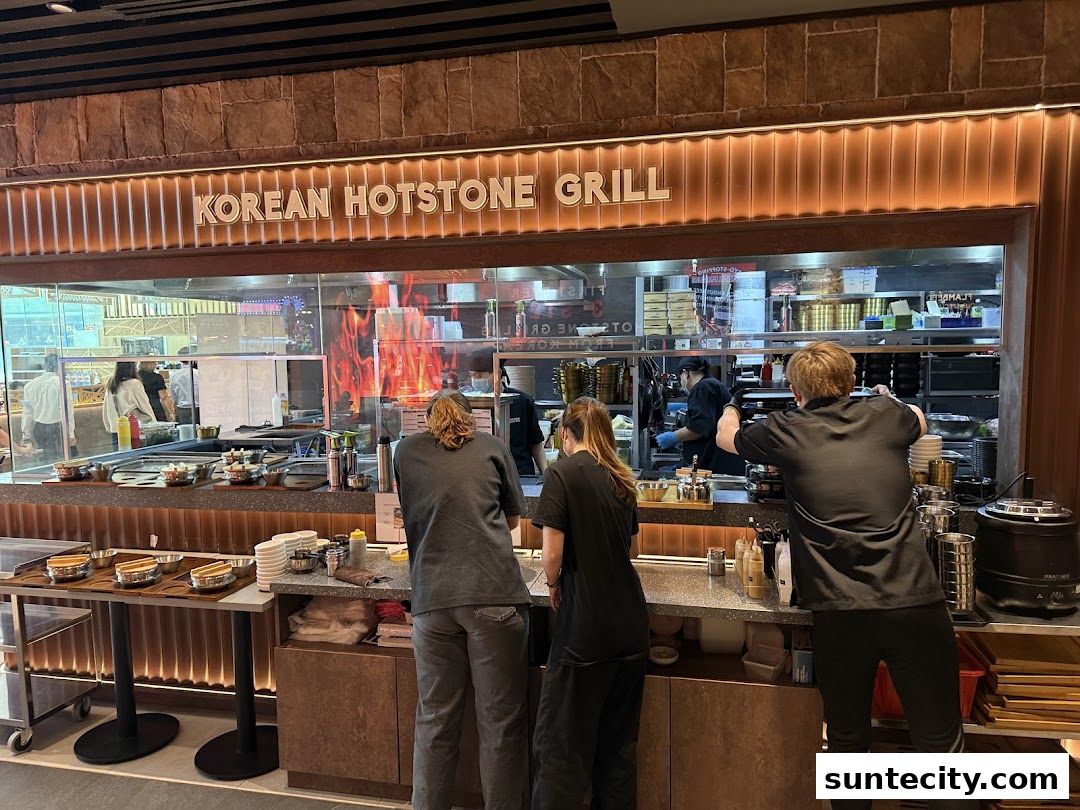 Staff working behind the counter at a Korean Hotstone Grill restaurant.