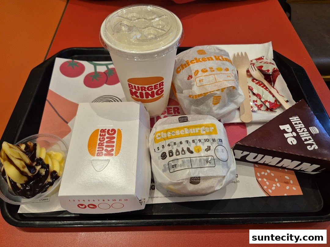 A Burger King meal featuring burgers, fries, a drink, and a Hershey's Pie on a tray.