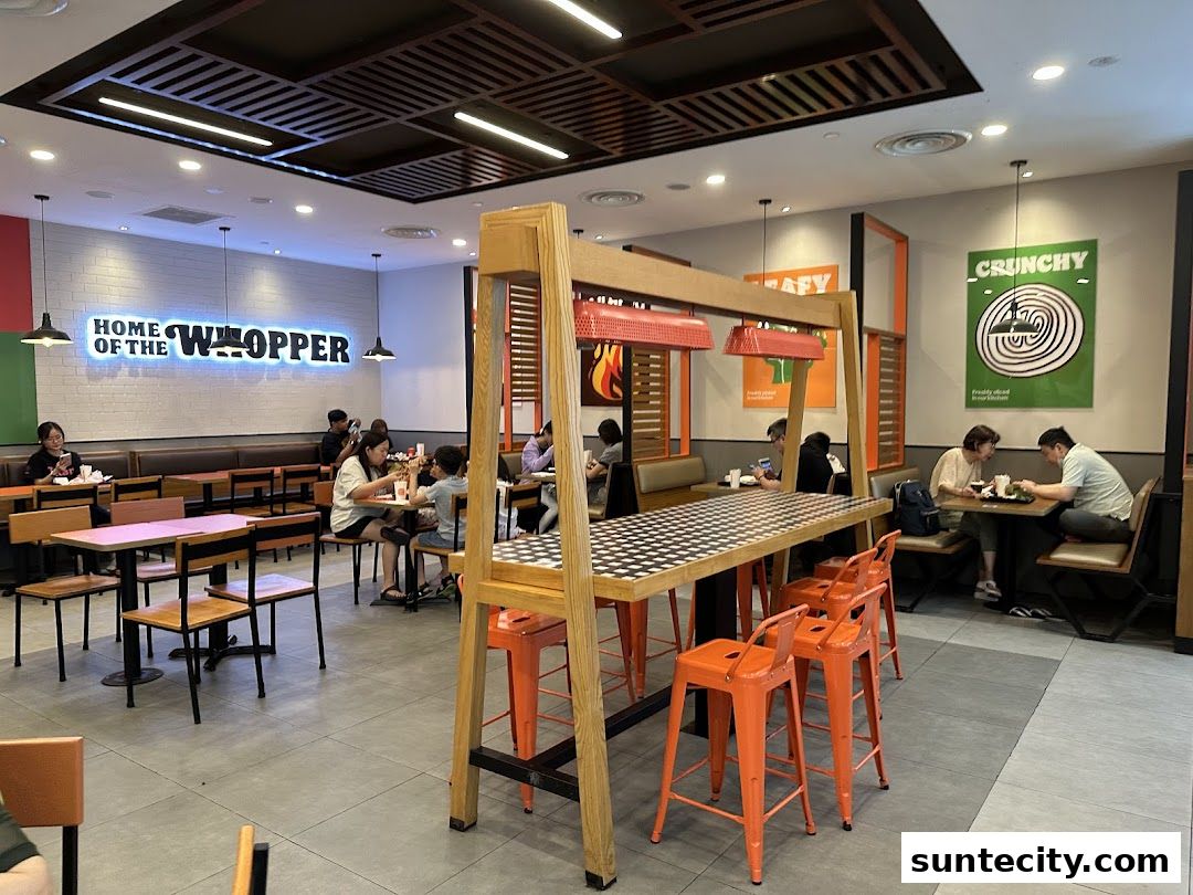 Interior of a Burger King restaurant with customers dining at tables.
