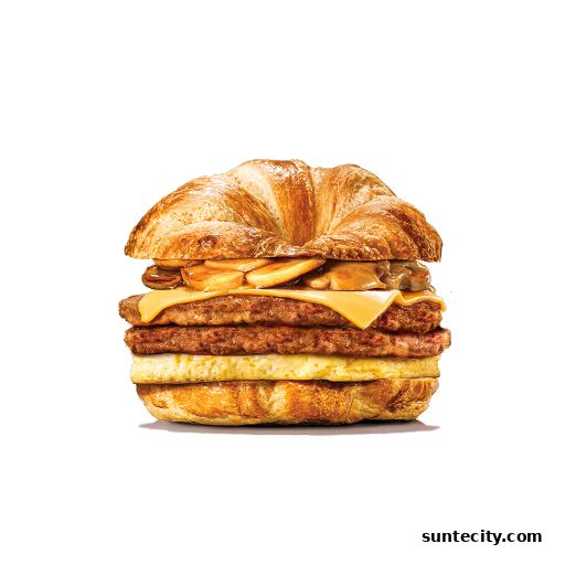 A delicious breakfast sandwich with sausage, egg, cheese, and mushrooms on a croissant.