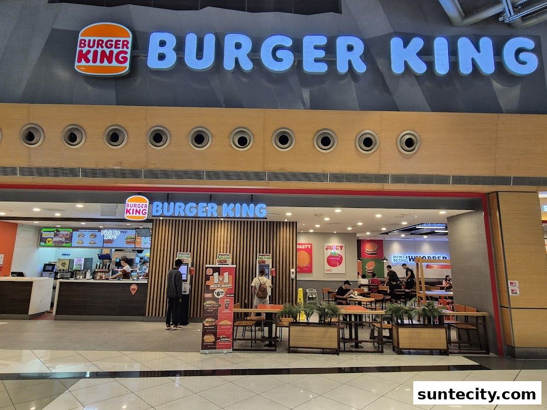 Burger King restaurant entrance with seating area and prominent signage.