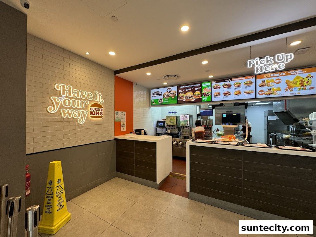 Burger King interior with a neon sign, menu boards, and a counter.