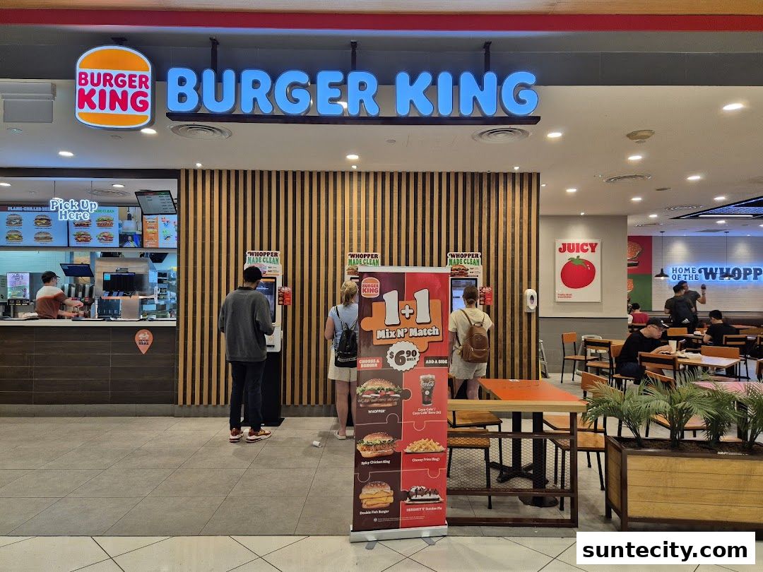 Burger King restaurant entrance with customers ordering and dining inside.