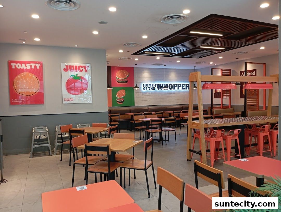 Interior view of a Burger King restaurant with seating, decor, and branding.
