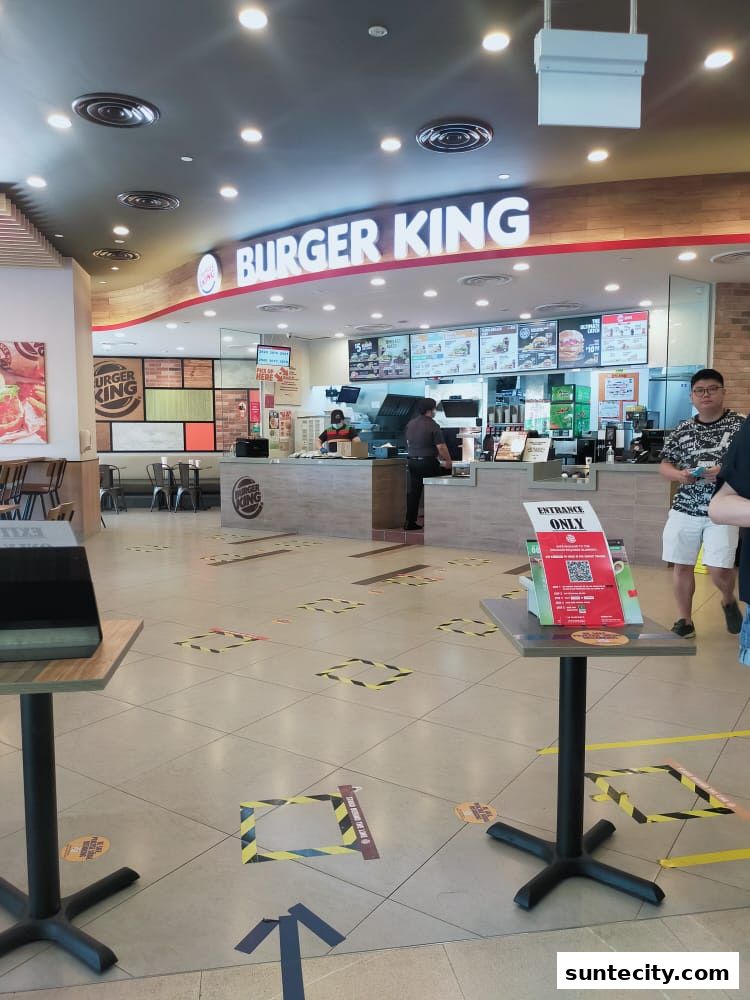 Interior view of a Burger King restaurant with social distancing markers on the floor.