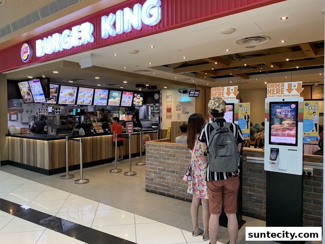Burger King restaurant interior with digital menus and ordering kiosks.
